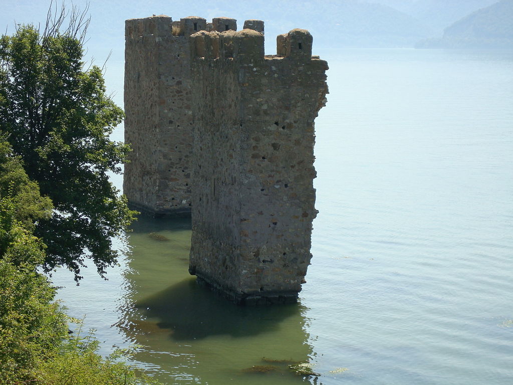 Old castle tower inside the Danube River in Romania near Orsova.