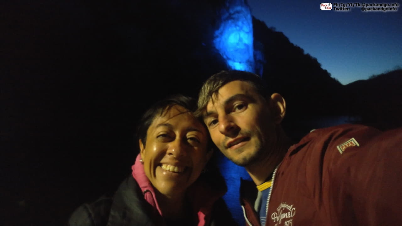 the head on the rock with light at night with two people selfie in Romania